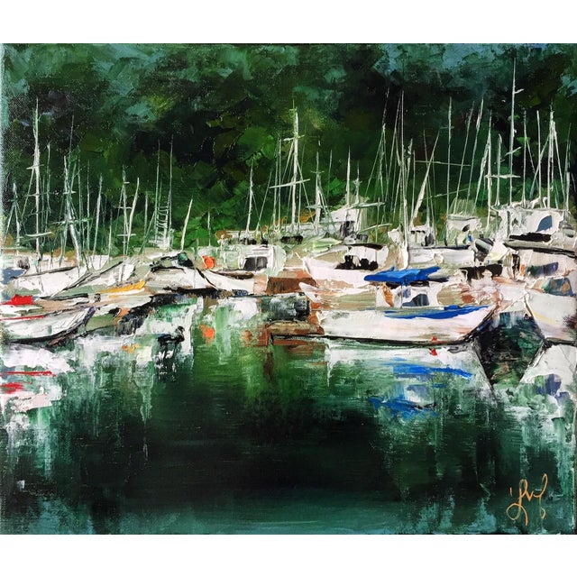 The Inlet captures a serene marina scene, where boats gently sway on calm waters, reflecting the vibrant colors of their...