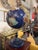 This striking decorative world globe features a richly saturated lapis-blue surface inlaid with detailed continental...