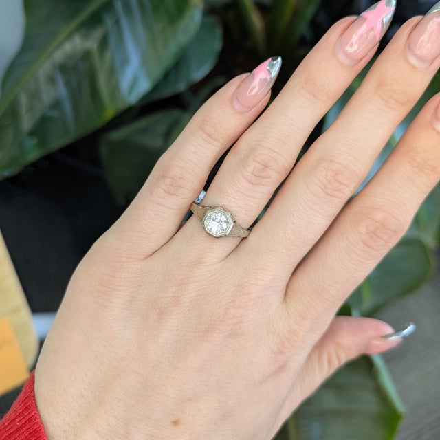 Crafted in solid 14K gold, this estate vintage ring features a brilliant 5mm natural round diamond, radiating timeless...