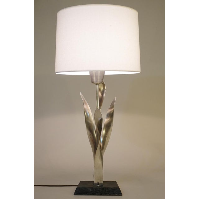 A minimal yet striking Mid Century Modern sculptural Nickeled Brass & Ebonized Ash wood"Tulip" table lamp designed and...