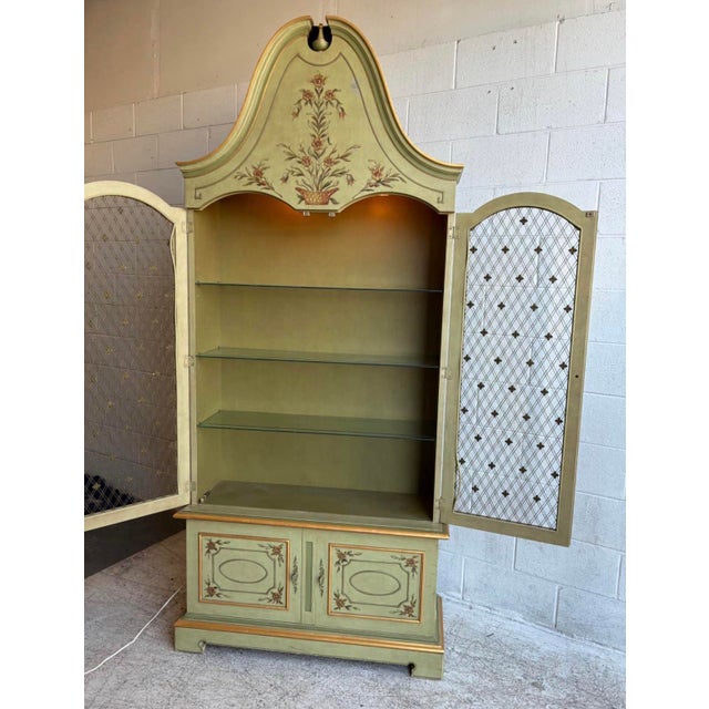 Offered is a green bonnet top French Regency style display cabinet by John Widdicomb, circa 1960s. This two-piece...