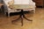 An English Turn of the Century mahogany and leather tilt top centre table with quadripod base and casters. Step into the...