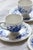 Charming set consisting of four antique white earthenware teacups and saucers. Featuring a deep blue floral design typical...