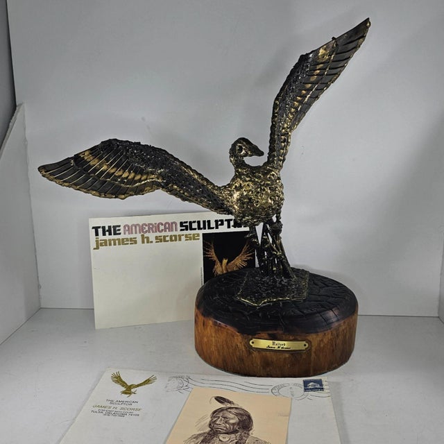This handcrafted bronze sculpture depicts a mallard in mid-flight, mounted on a polished wooden base with an engraved...