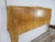 An elegant 1950s vintage double bed, characterized by soft, sinuous lines, rounded shapes, and a refined honey hue that...