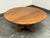 Design Plus Gallery presents a Mid 20th Century Modern Round Wood Coffee Table with Cross Base. This American made table...