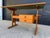 Danish modern, height and tilt adjustable, teak drafting table features a vinyl top and 2 drawer detachable cabinet. The...