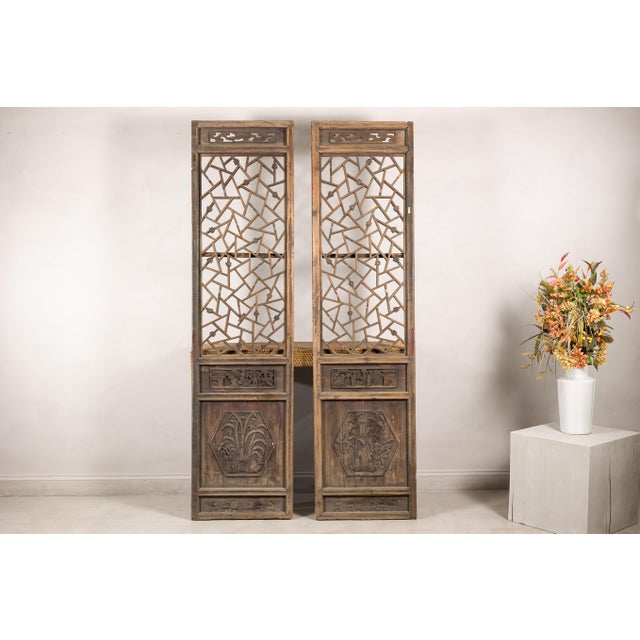 This pair of antique Chinese architectural panels features an intricate openwork lattice design combined with deeply...