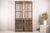 This pair of antique Chinese architectural panels features an intricate openwork lattice design combined with deeply...