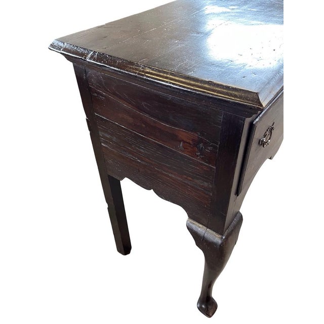 Queen Anne console table hand-made in England in the early 1800s using oak and pegged construction. The table has a...