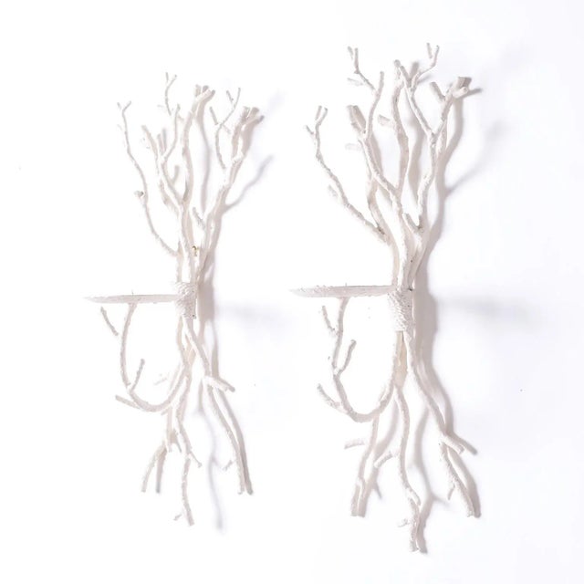 Pair of mid century faux coral wall sconces crafted in metal and painted white with one spiked candle bobeche each.