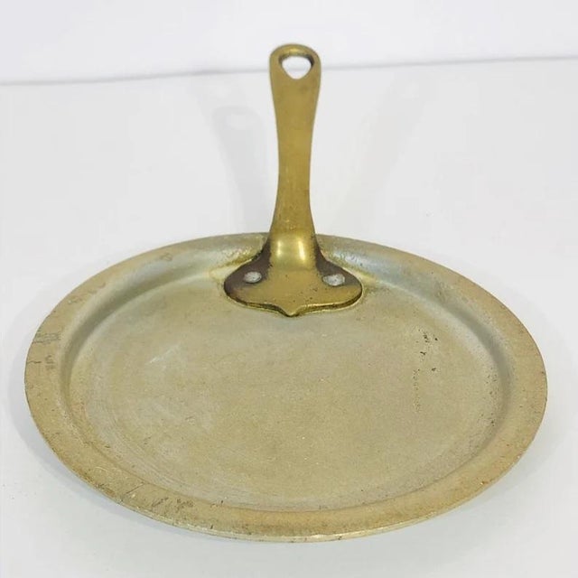This is a most delightful small antique metal saucepan lid from the 1920s with a sturdy riveted brass handle....