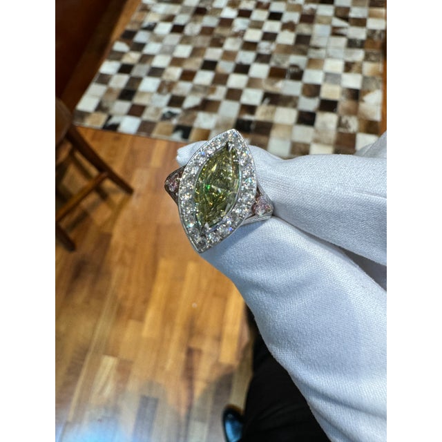 This is part of Chairish’s Fine Jewelry assortment. GIA certified 1.92-carat marquise cut Fancy Deep Brownish Greenish...