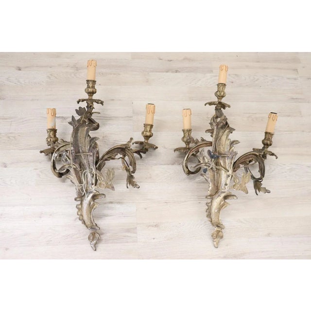 Beautiful and refined Italian circa 1890s pair of wall lights or sconces three lights. Made of golden bronze. Decoration...