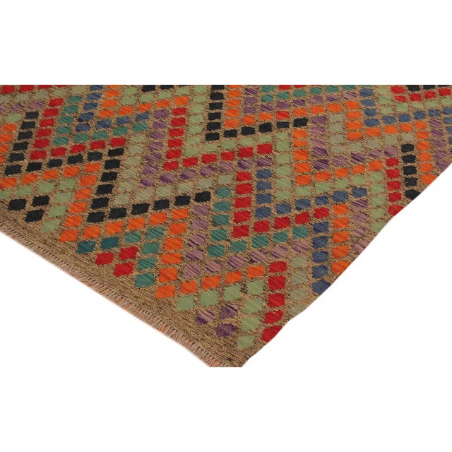 "Add a touch of elegance to your home with this casual chic hand woven Tribal Kilim wool rug. Constructed on a loom by...
