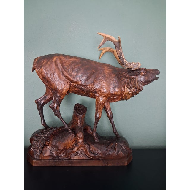 This wooden Stag or Elk sculpture was masterfully carved by woodcarvers from Germany's Black Forest region. Its...