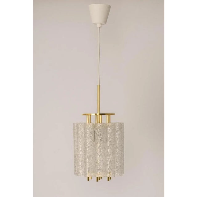 Fantastic mid-century pendant lights by doria, germany, manufactured circa 1960-1969. A lot of murano glass cylinders are...