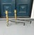 A handsome and well-proportioned pair of antique brass fireplace andirons featuring classic turned columnar shafts and...