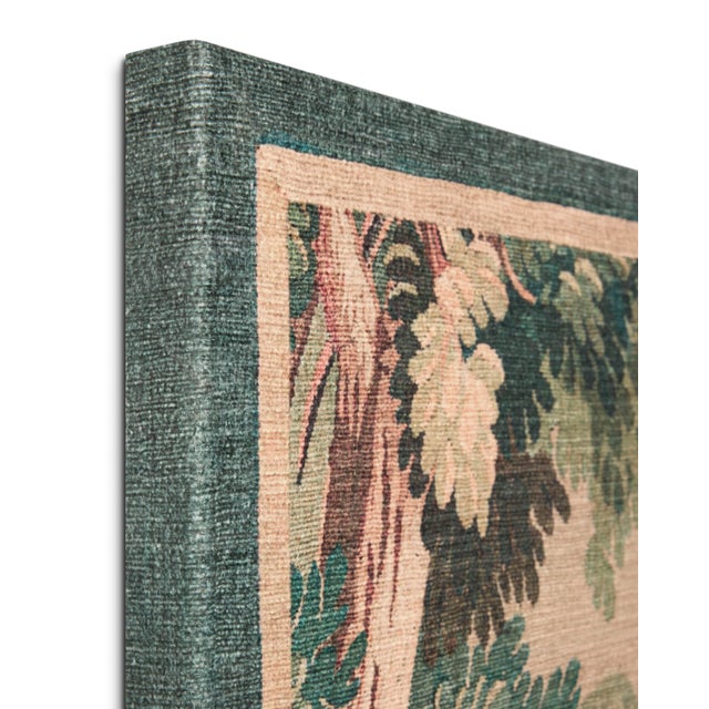 Hidden Hamlet wall art is a large tapestry with a mythic castle and forest pattern in antique green and natural brown...