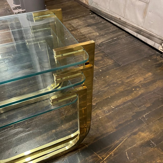 A set of three cantilevered glass and brass nesting tables attributed to Milo Baughman for DIA (Design Institute of...