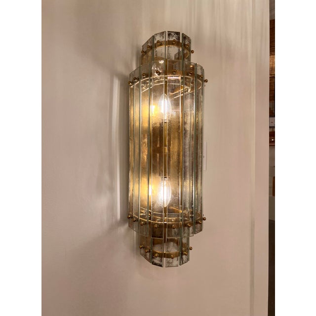 The Cadence Large Tiered Sconce was designed by Carrier and Company for Visual Comfort & Co. Its 21-inch silhouette...