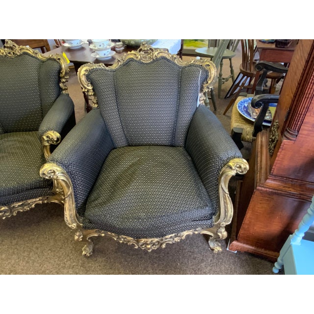 Pair of carved and gilt Rococo chairs, circa 1900. Bergère chairs have been reupholstered with a contemporary fabric....