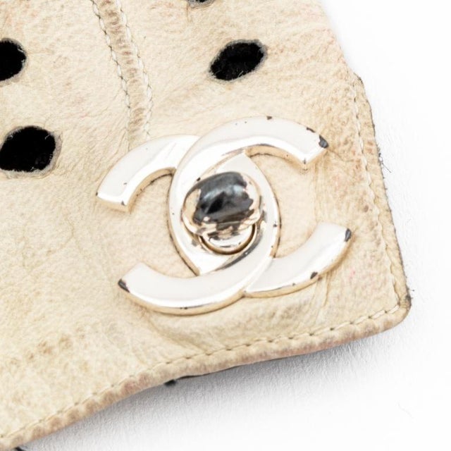 Pair of Chanel Black and White Perforated Leather Gloves, with silver tone "CC" logo. 7.25" L x 4.5" W. Provenance: From a...