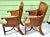 A stylish pair of vintage bamboo and rattan armchairs featuring woven wicker backs and sculptural bent bamboo frames....