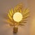 The Palm Sconce brings tropical elegance into any setting with its intricately hand-molded palm leaf silhouette, casting...