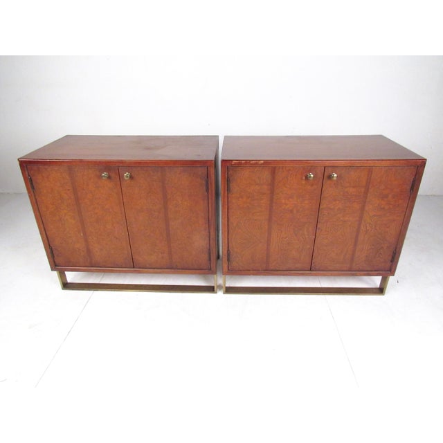 This stylish pair of Thomasville cabinets feature beautiful vintage finish with inlaid brass legs. Midcentury style design...