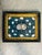This decorative shellwork plaque features a beautifully balanced arrangement of natural seashells displayed against a rich...