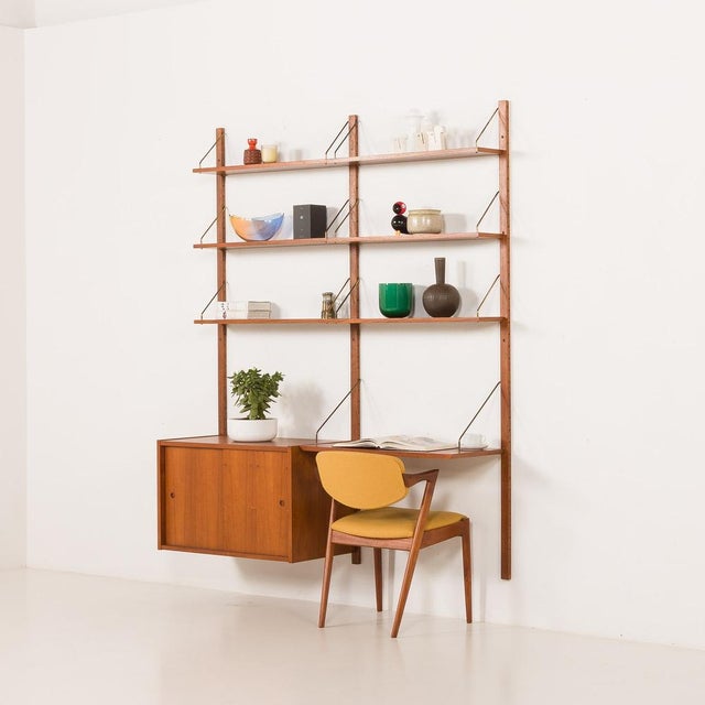 This elegant teak wall unit was made in denmark in the 1960s and perfectly reflects the spirit of mid-century modern...