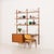 This elegant teak wall unit was made in denmark in the 1960s and perfectly reflects the spirit of mid-century modern...