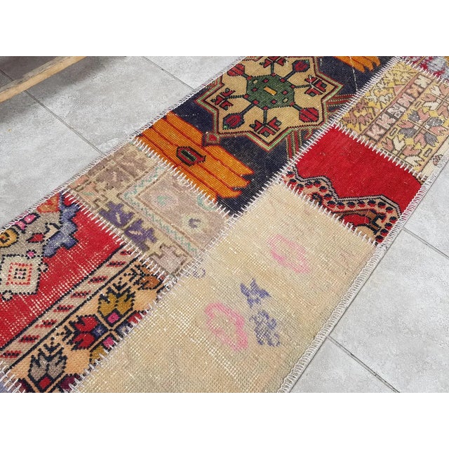 This is a vintage Turkish Oushak rug from the Mid 20th Century. The piece was hand-knotted.