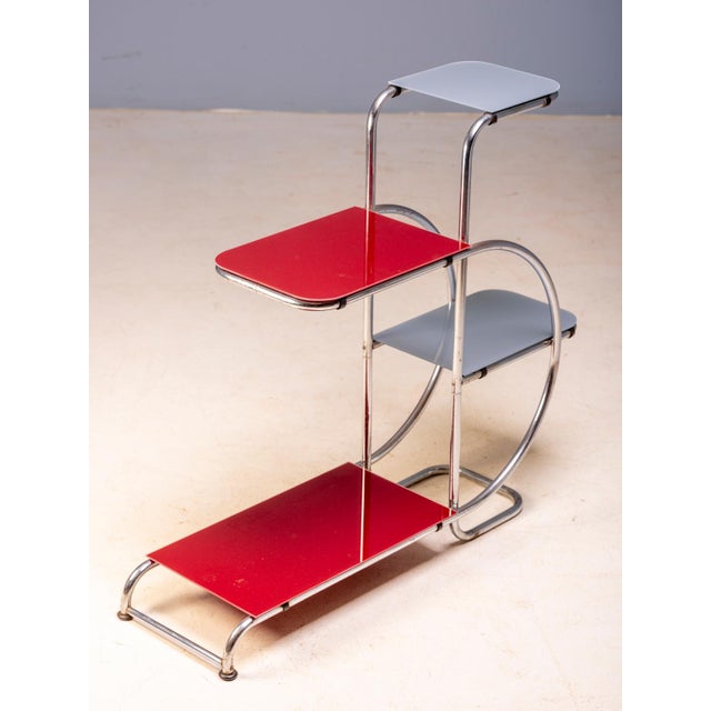 An elegant Bauhaus plant stand designed by Emile Guyot, featuring a graceful chrome-plated tubular steel frame fitted with...