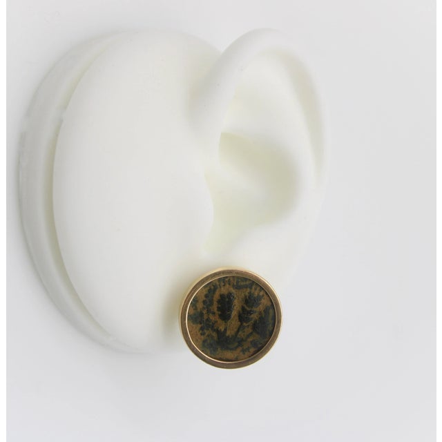 This is part of Chairish’s Fine Jewelry assortment. These 14k gold earrings feature ancient coins that were minted in...