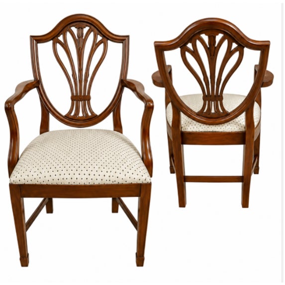 Substantial Baker dining table accompanied by ten coordinating dining chairs, including two armchairs and eight side...