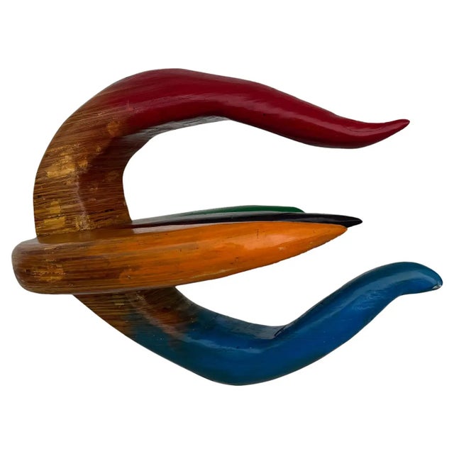 This Hy Farber wood floral sculpture features dynamic, organic petal forms in vivid hues—red, orange, green, blue, and...