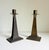 A pair of Arts & Crafts style candlesticks, circa late 1800s to early 1900s. Clean and modern form paired with a rustic,...