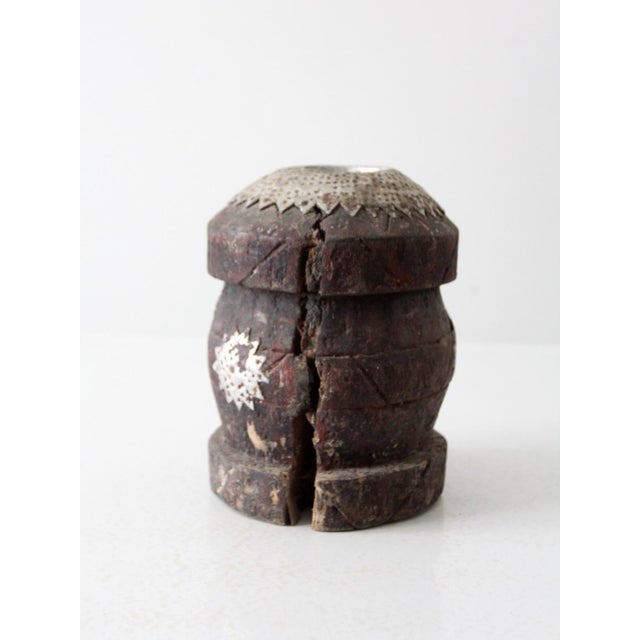 This antique wooden mortar, with its intricate metalwork and weathered finish, makes a captivating decorative piece. Its...
