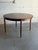 This beautiful oval dining table displays a highly streamlined form featuring tapered legs and a hidden center expansion...