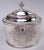George III sterling silver tea caddy with spoon. Made by Hester Bateman in London in 1784. Oval bowl with straight sides....