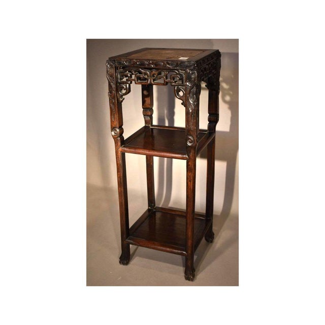 A Chinese carved hardwood 19th century stand. Deep and flowing carving along with an excellent patina completes the charm...