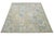 This hand-knotted wool rug has a light blue background adorned with brown and yellow accents in an all-over design. This...
