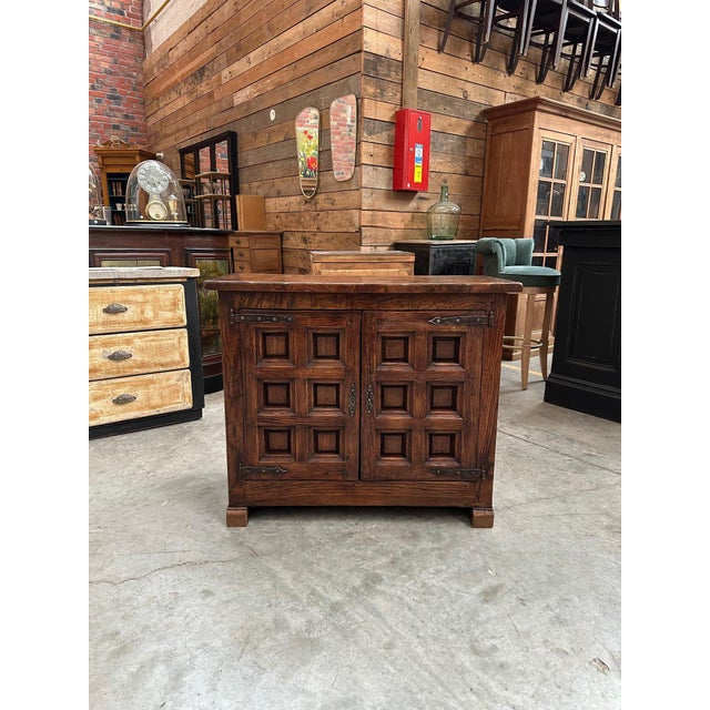 This brutalist sideboard in solid elm has been fully restored. It consists of two carved doors that lock and open onto a...