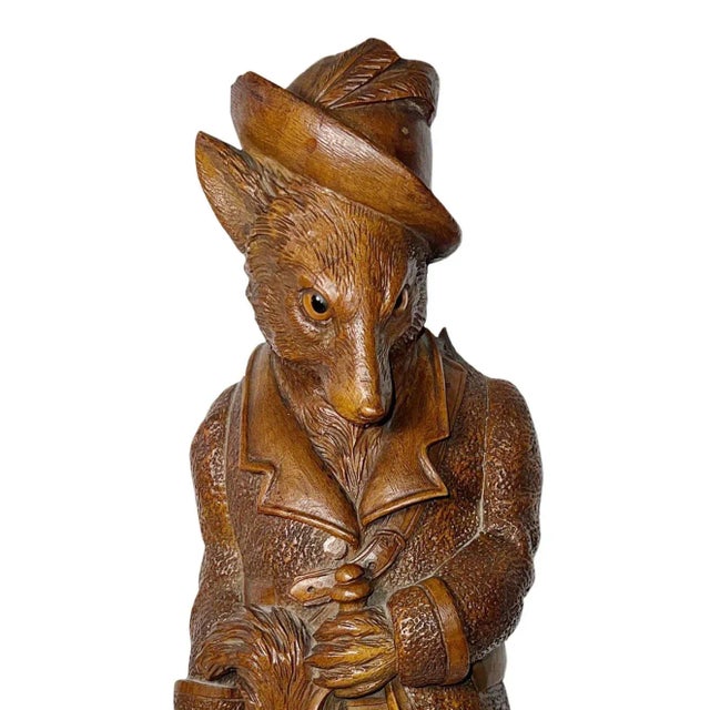 Black Forest, carved wood, whip designed in the shape of a dog wearing a hat and glass eyes. Attached to the back is a...