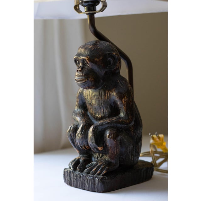 The lamp measures approximately 9.5” to the top of the monkey figure and 11” to the base of the light socket. Lamp base is...