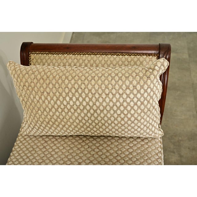 Dimensions: 28 ¾” H x 72 ¾” W x 24 ¼” D A graceful 19th-century French Empire daybed, expertly carved from solid mahogany...