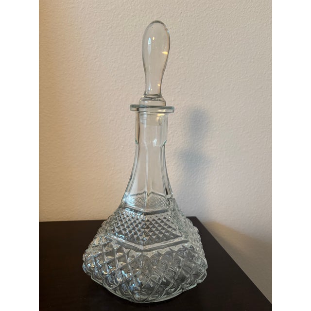 Elegant and richly detailed, this vintage clear glass decanter features a striking six-sided form with classic diamond-cut...
