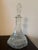 Elegant and richly detailed, this vintage clear glass decanter features a striking six-sided form with classic diamond-cut...